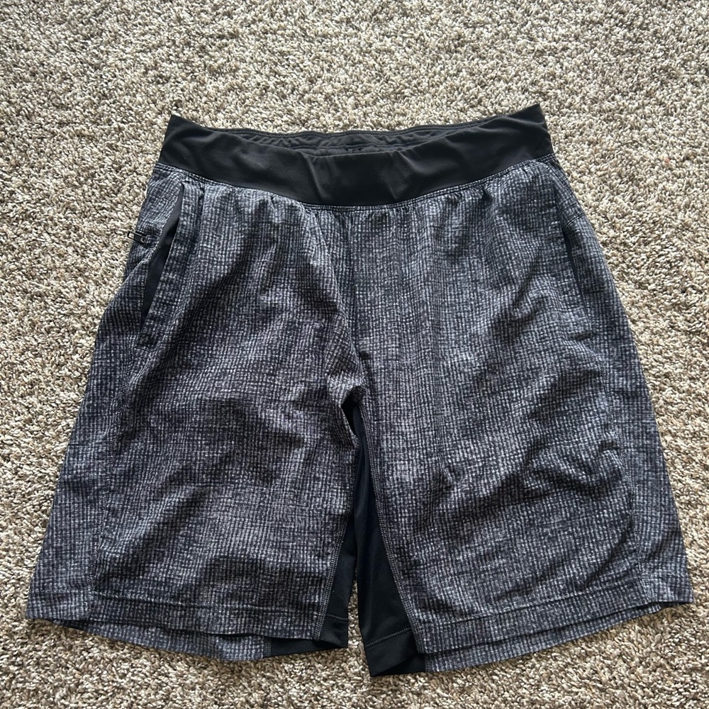 Men’s Lululemon linerless grey and black shorts, 9”.